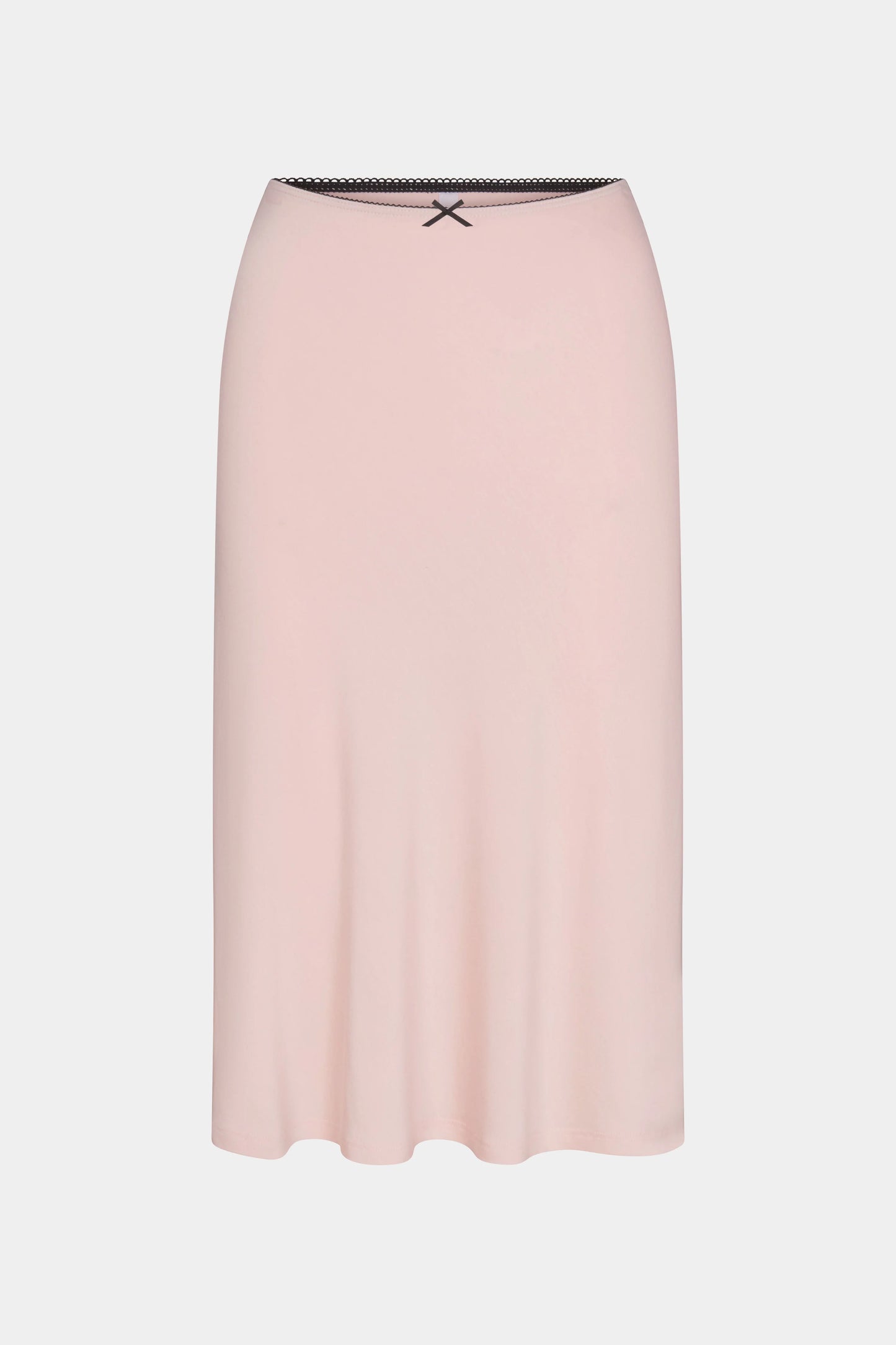 a midi length slip skirt in a petal pink color with a satin bow at the waist and contrasting elastic trim