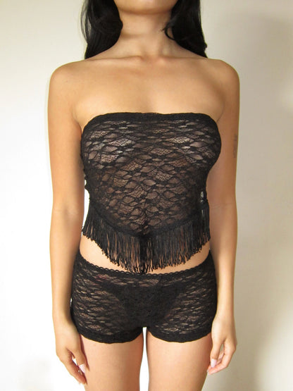Black lace frill strapless top and shorts set on a neutral background