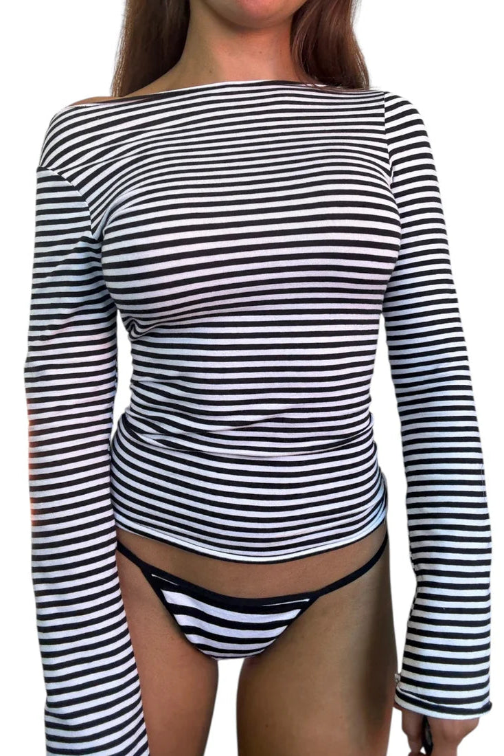 Person wearing a black and white striped long-sleeve top and matching underwear on a white background