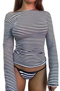 Person wearing a black and white striped long-sleeve top and matching underwear on a white background