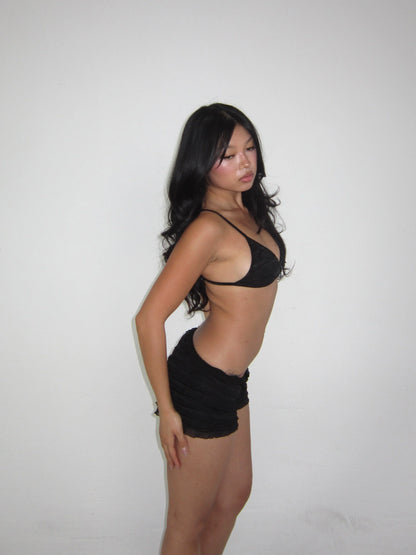 girl wearing black lace bra and short set