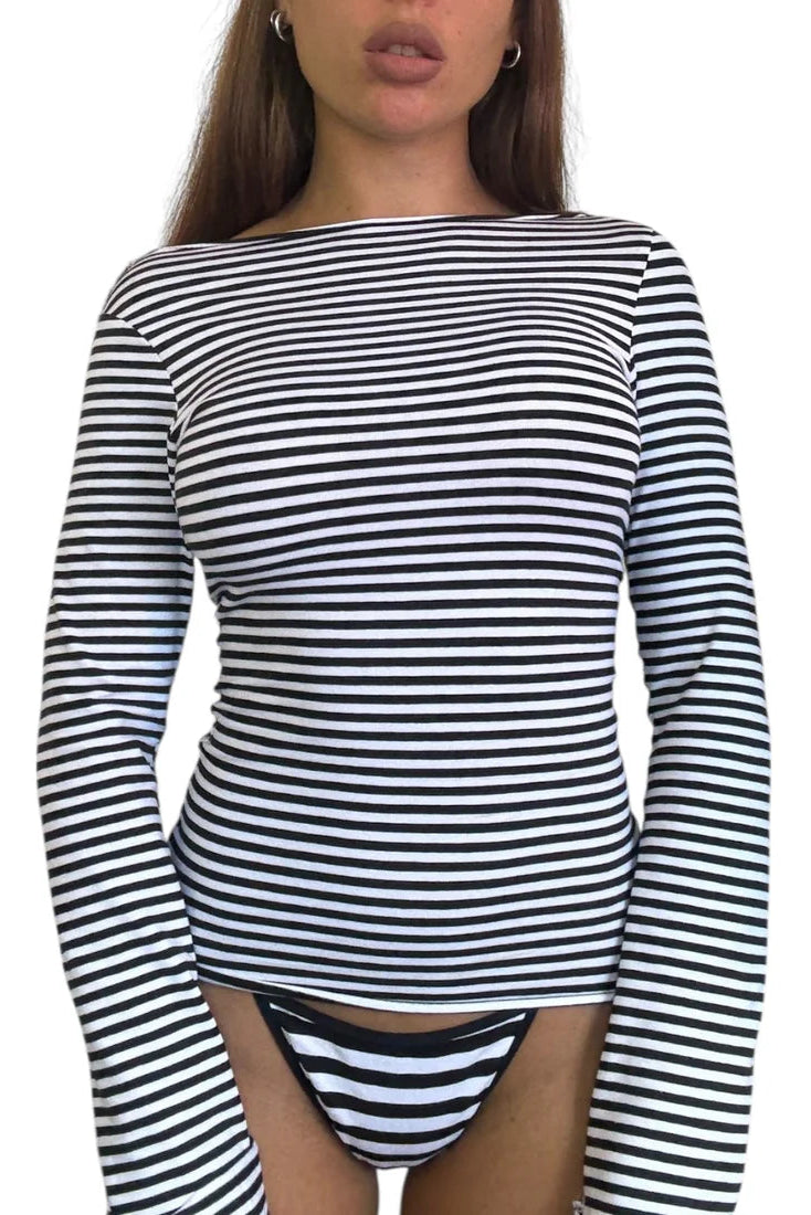 Black and white striped long-sleeve top worn by a model on a white background
