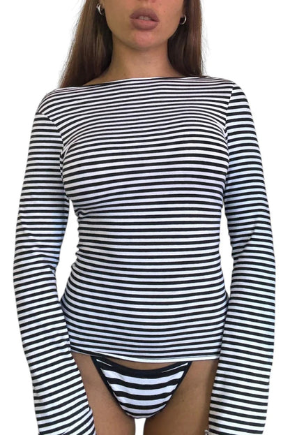 Black and white striped long-sleeve top worn by a model on a white background