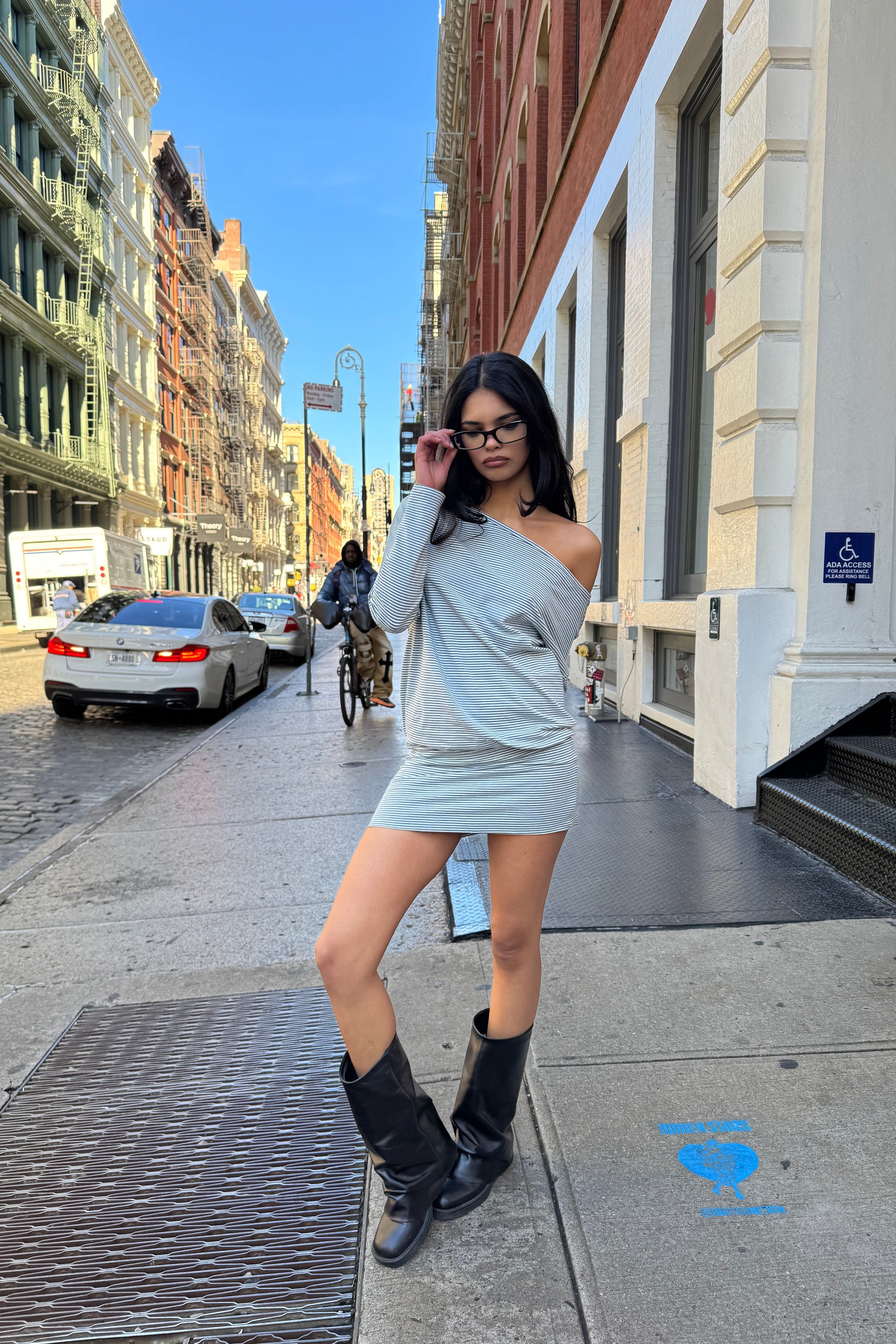 girl wearing a grey and white striped off the shoulder y2k 90s short dress
