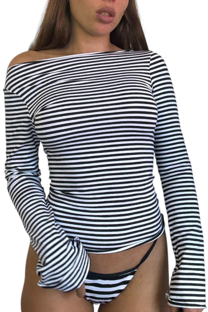 Woman wearing a black and white striped long-sleeve top on a white background