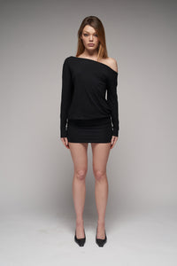 model wearing a black off the shoulder mini dress with long sleeves