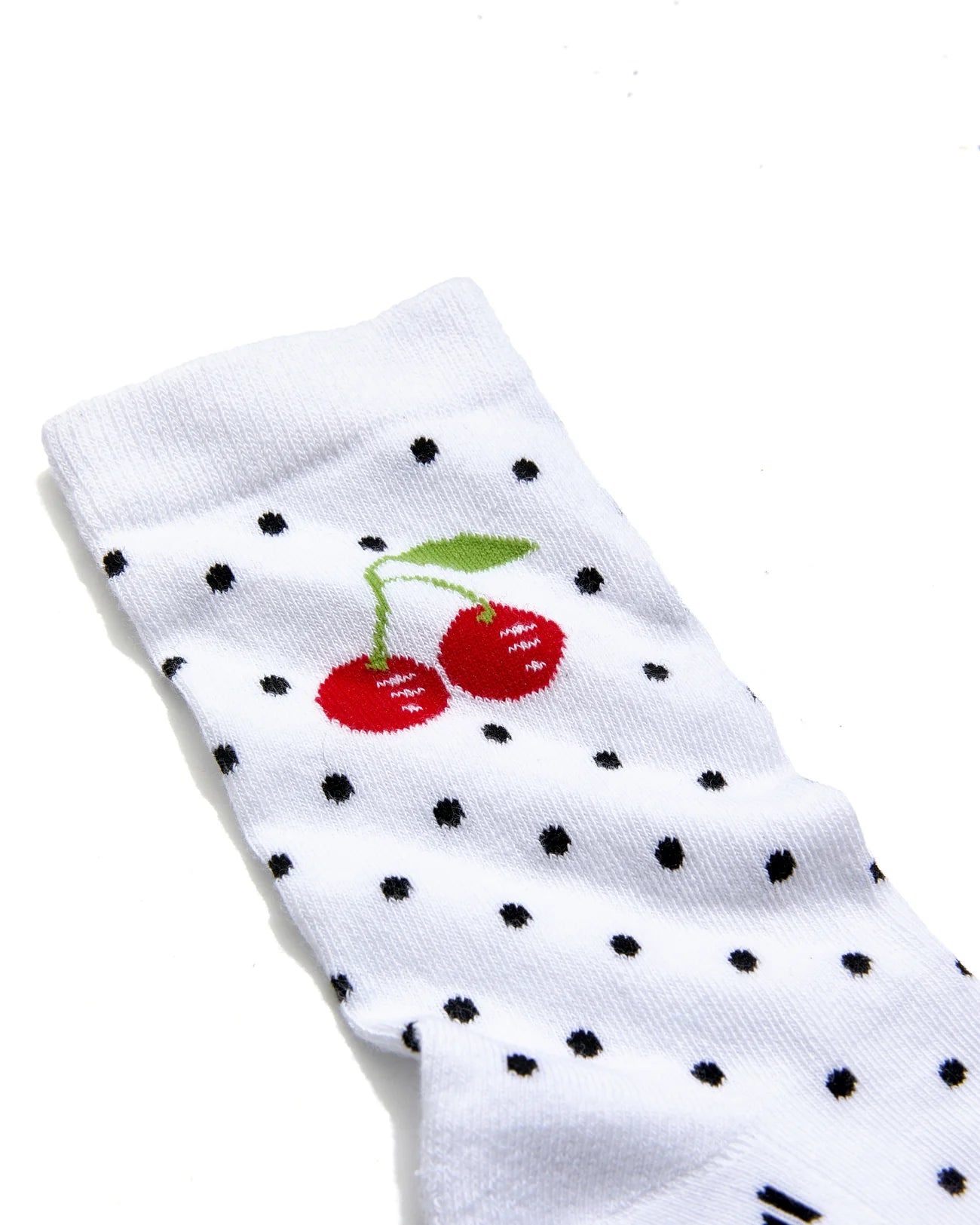White sock with black polka dots and red cherries on a white background