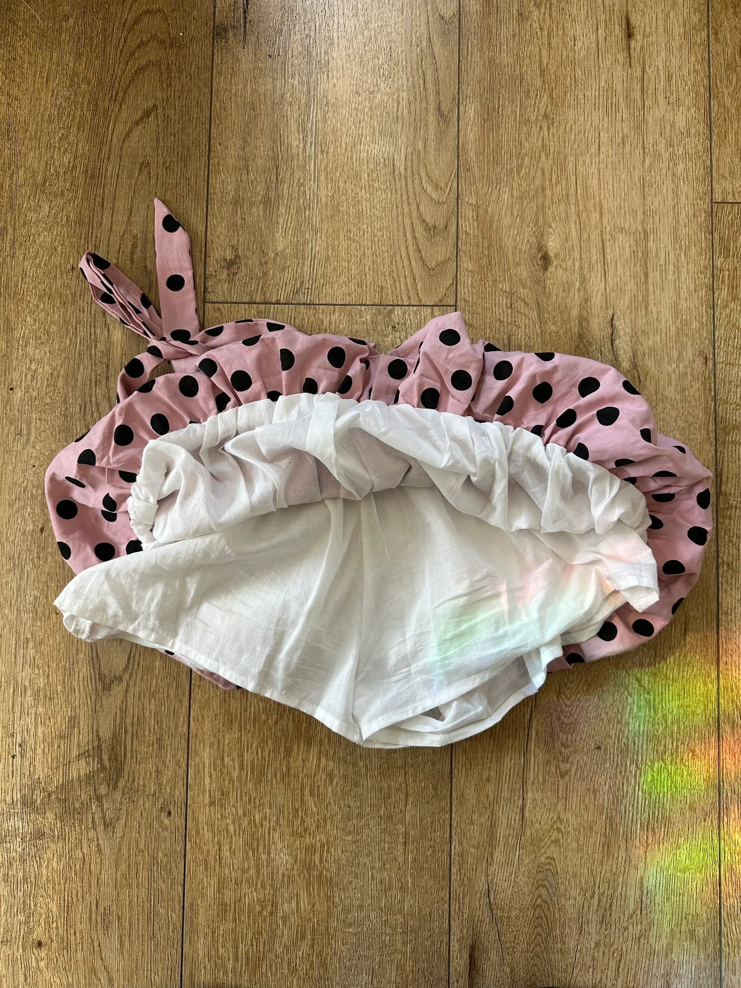 pink polka dot skirt wooden floor