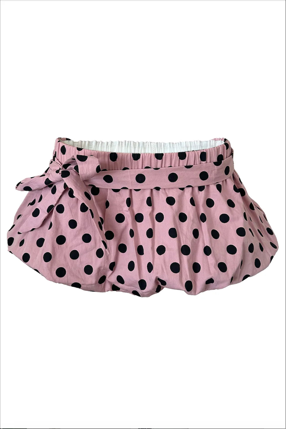 Pink skirt with black polka dots on a white background